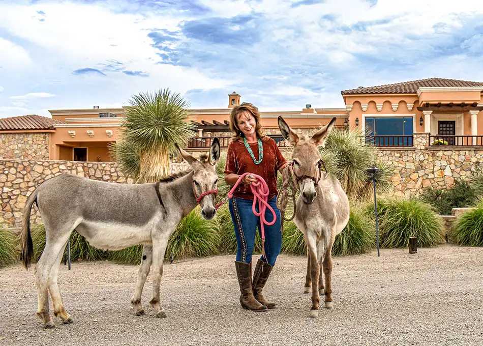 Alma Franzoy-Capron in front of her home with her donkeys
