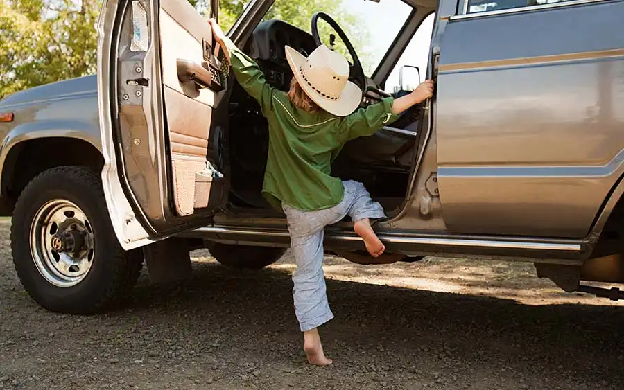 Child climbing into truck