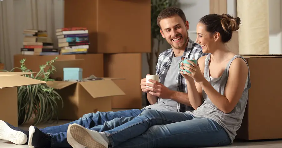 couple relaxing on floor after moving