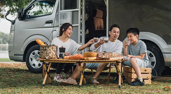 Family camping near van