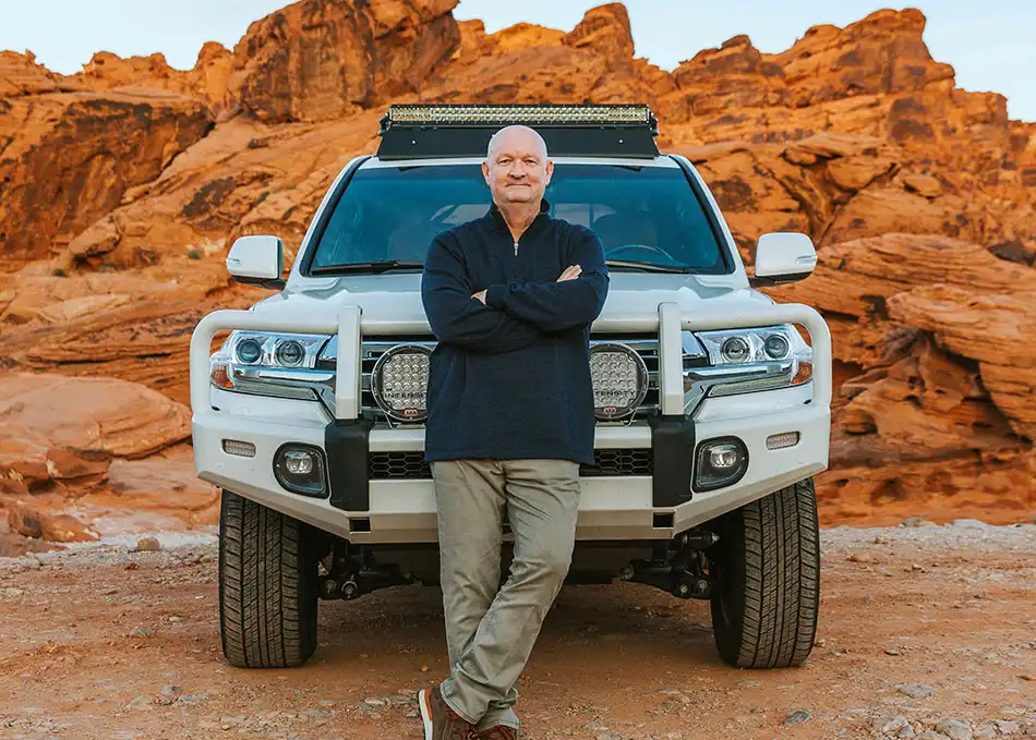Tim Woodruff in front of truck and red rocks