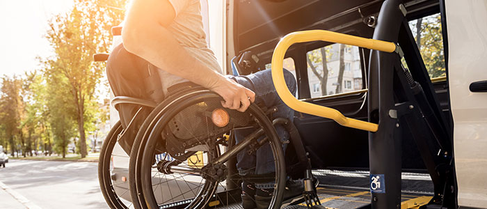 man in wheelchair entering van